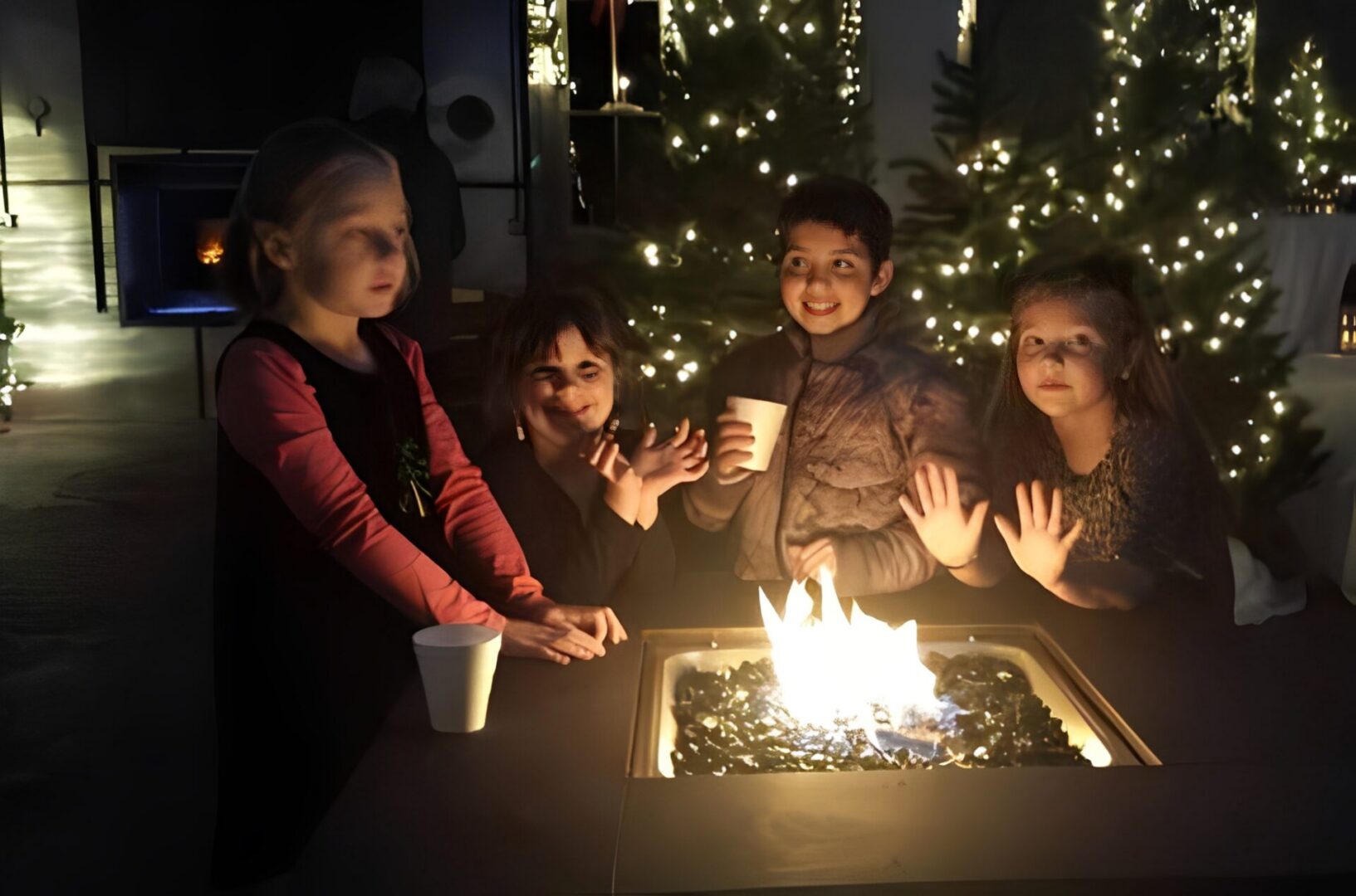 Children gathered around an outdoor fire pit.