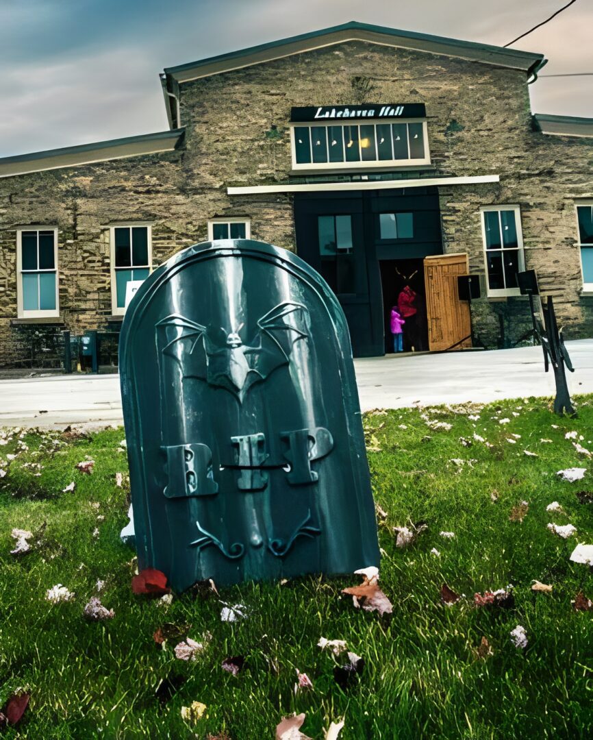 Halloween tombstone decoration outside brick building.